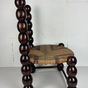 Brutalist wood turned bobbin low rush chair n the style of Charles Dudouyt