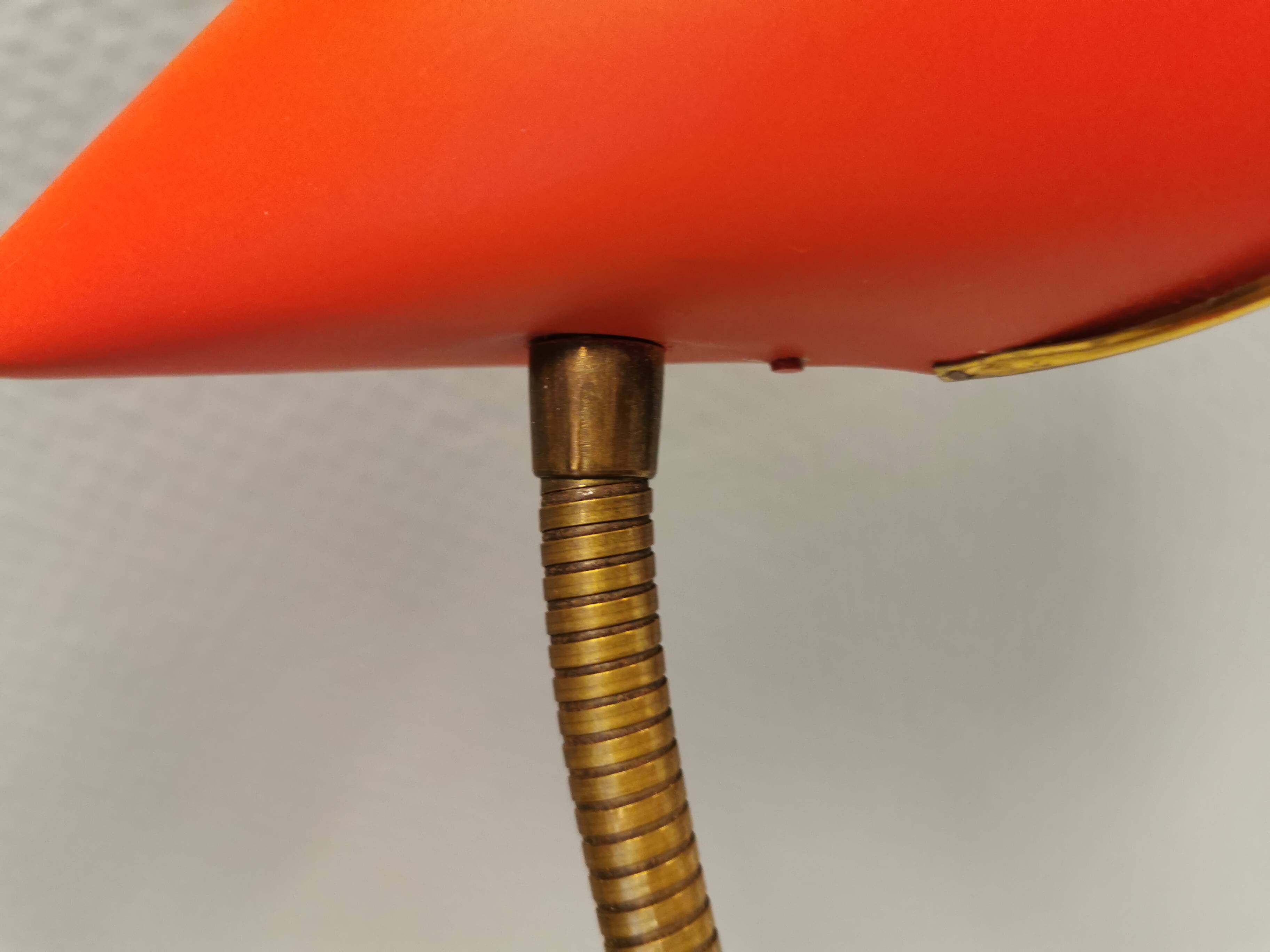 Danish red lacquered wall light with brass details. Estimated 1980s