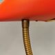 Danish red lacquered wall light with brass details. Estimated 1980s
