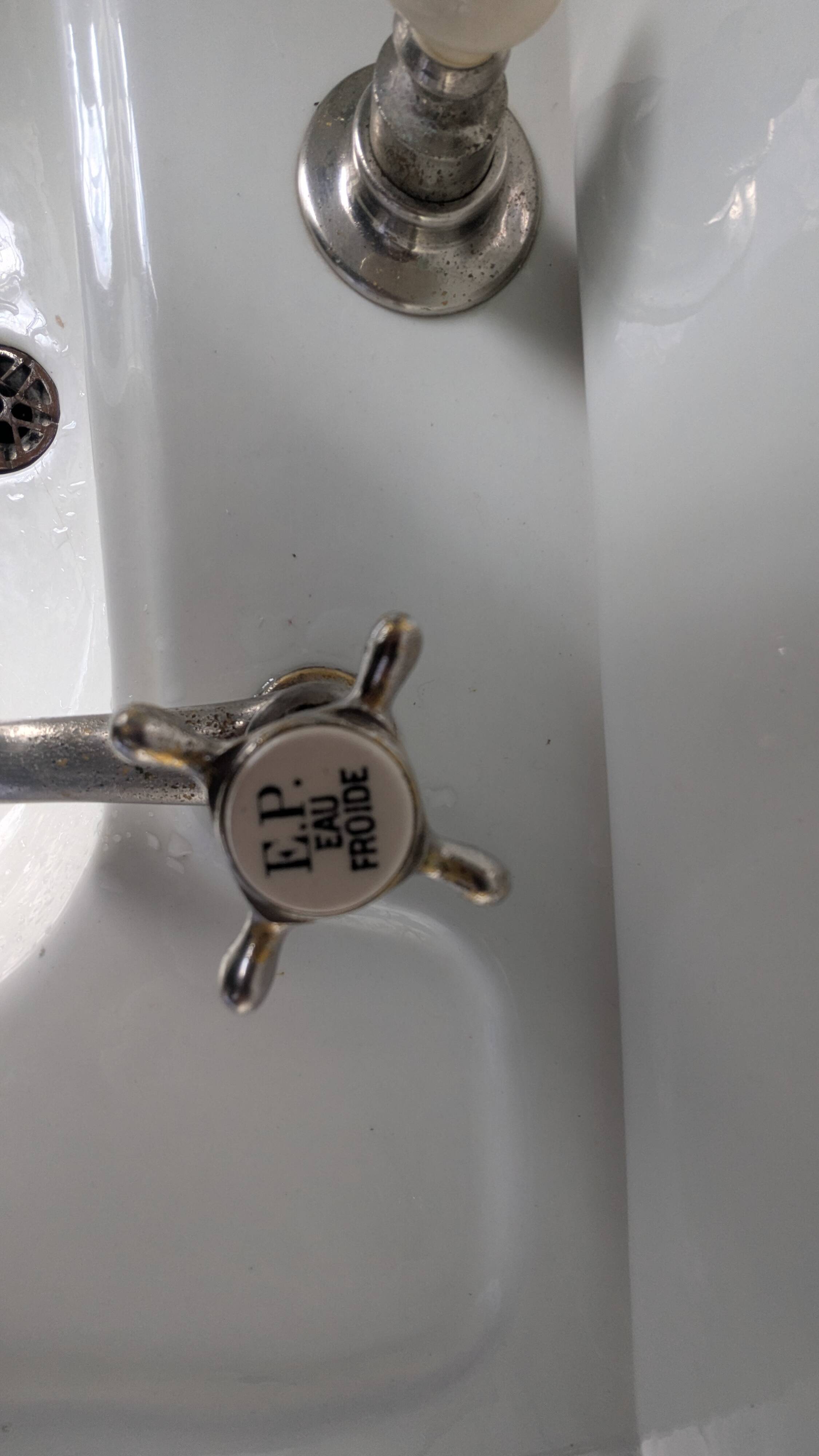 Set of a sink and its retro ceramic splashback.