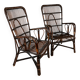Pair of large dark rattan armchairs with high backs.
