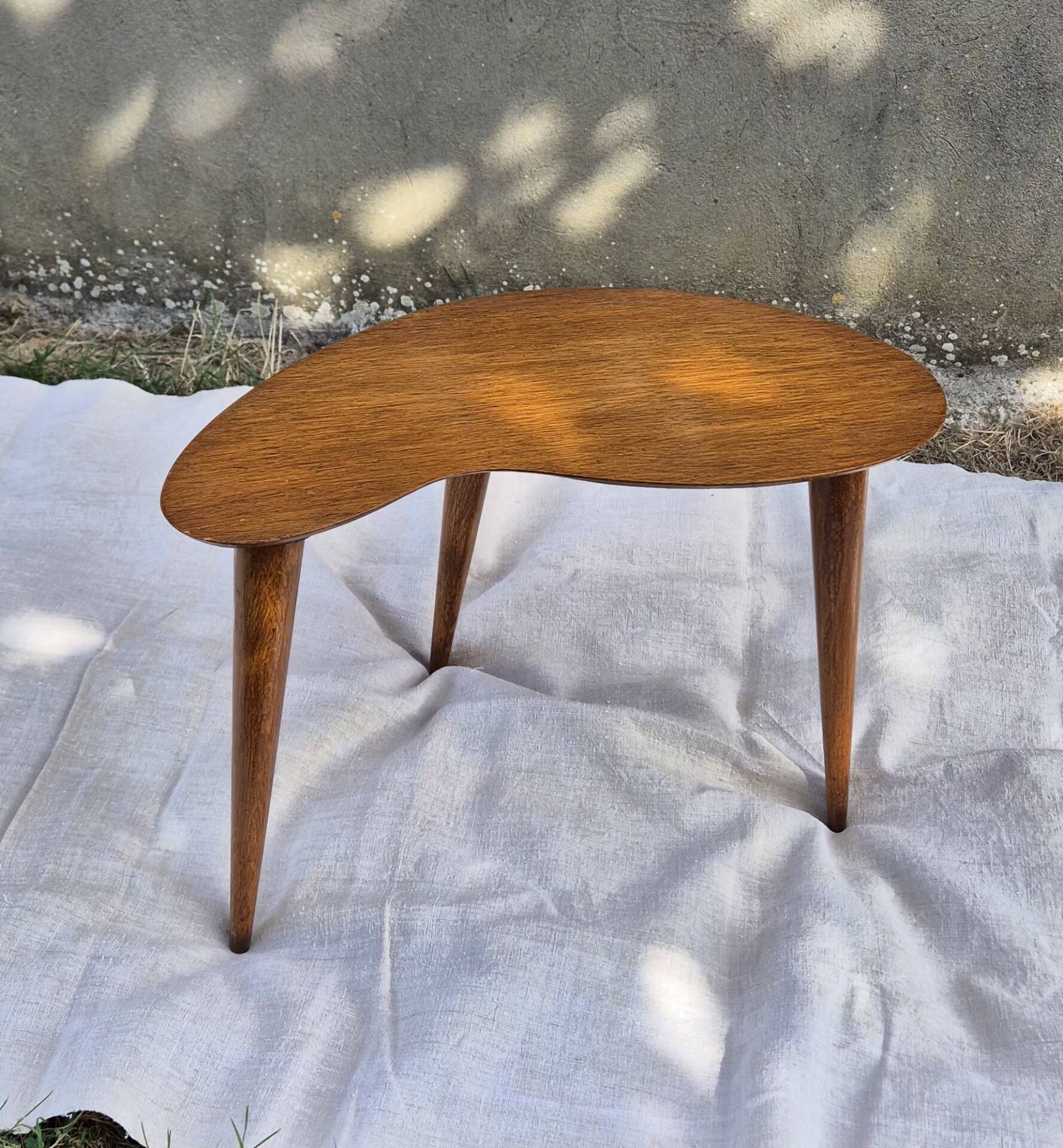 Vintage Scandinavian bean side table with wooden tapered legs.