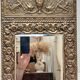 Bevelled mirror from the 1930s in repoussé brass.