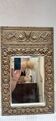 Bevelled mirror from the 1930s in repoussé brass.