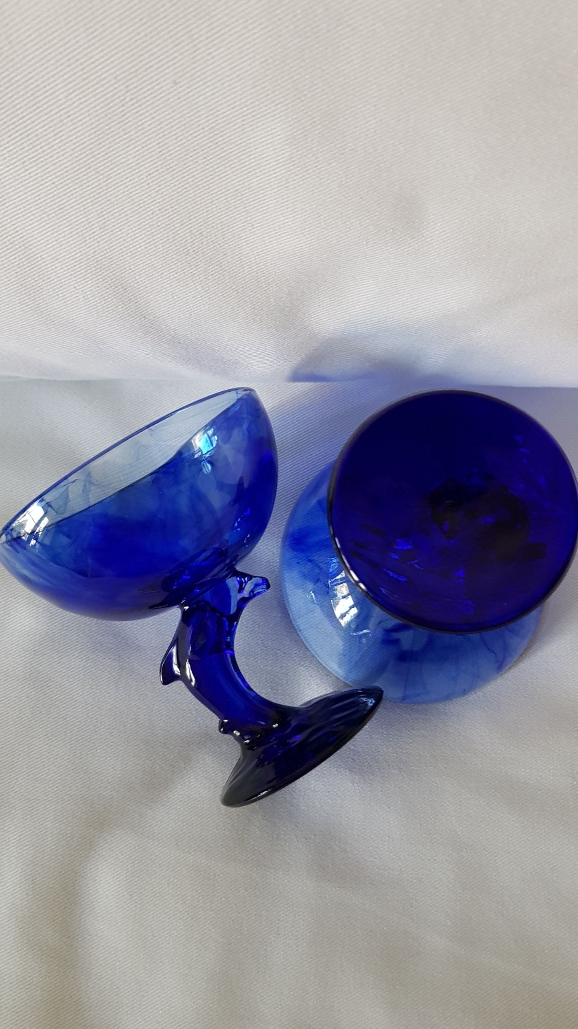 Set of 2 dolphin dessert cups in blue glass.