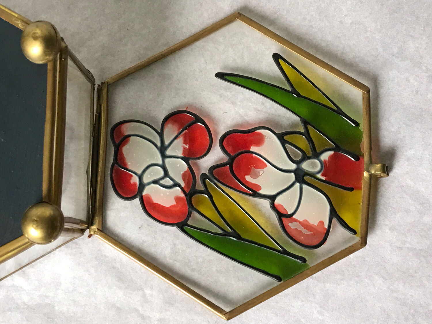 Glass box and hexagonal brass enamelled floral decoration