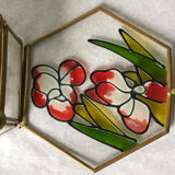 Glass box and hexagonal brass enamelled floral decoration