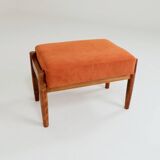 Vintage armchair and footrest in orange corduroy.
