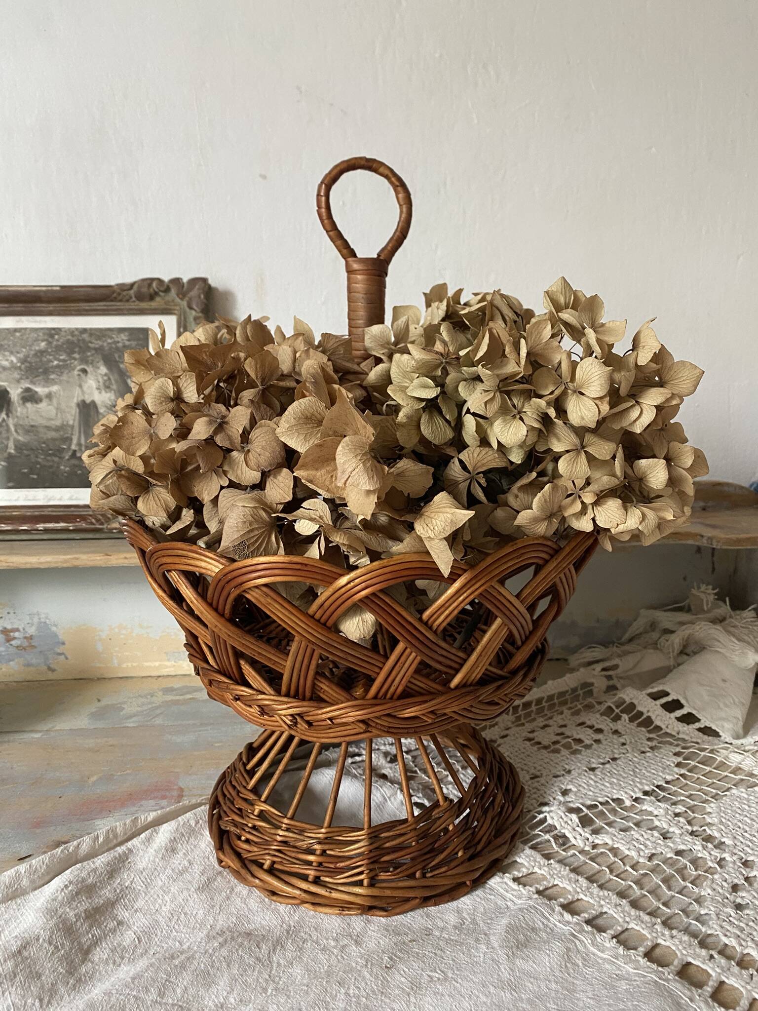 Wicker fruit bowl on a stand