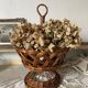 Wicker fruit bowl on a stand