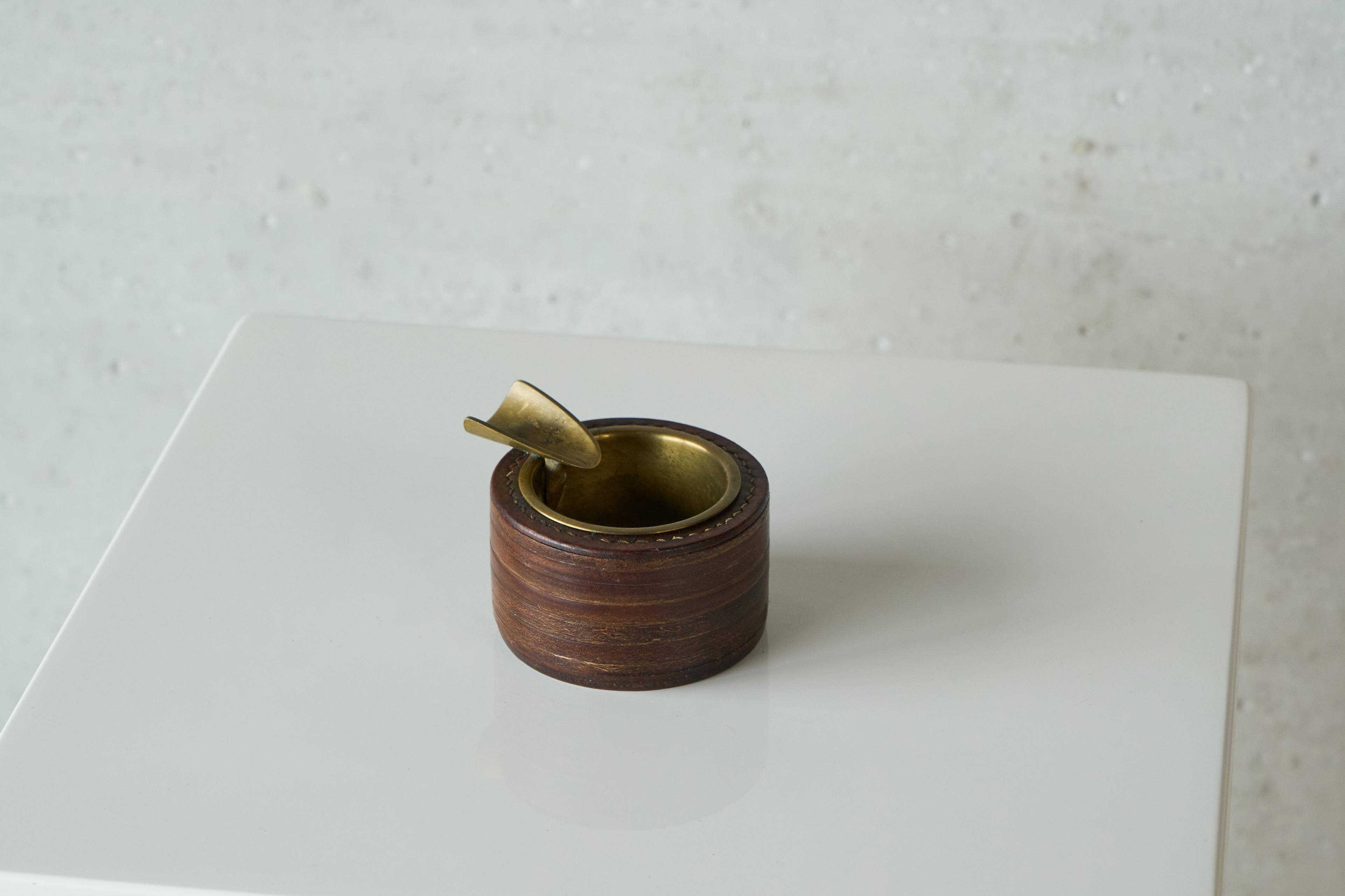 Vintage leather and patinated brass ashtray, 1960s, mid-century design.