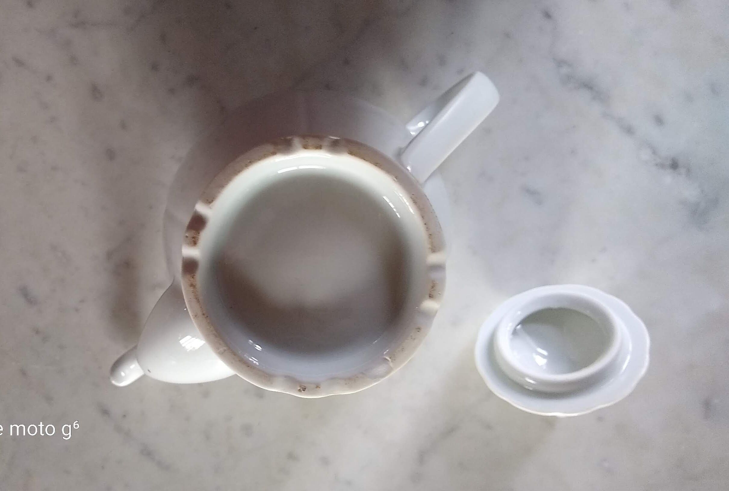 White porcelain teapot with acorn-shaped cap