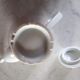 White porcelain teapot with acorn-shaped cap