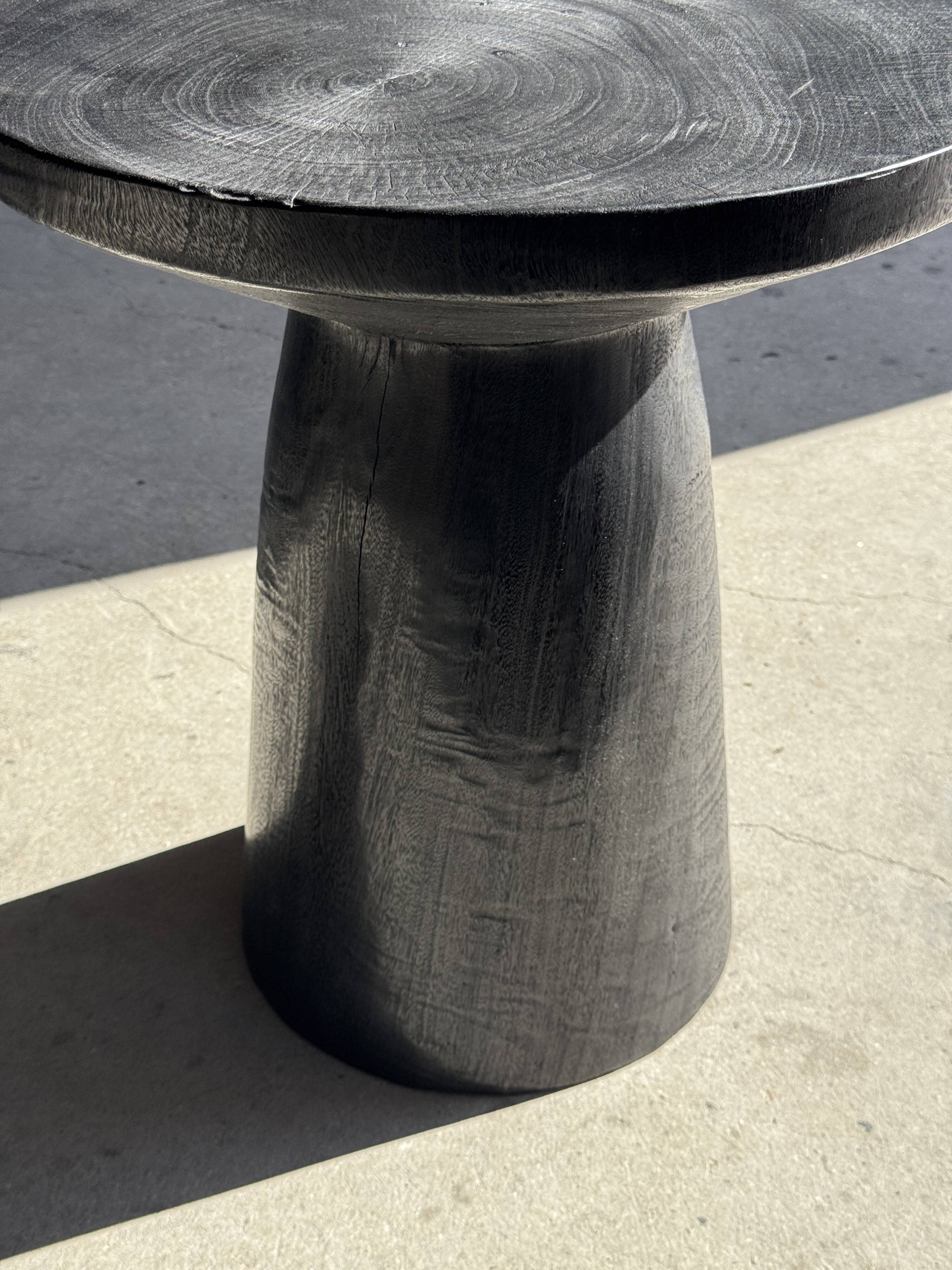 Black solid mango side table (monoxyle) with conical legs