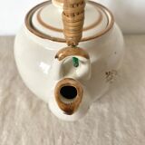 Vintage porcelain and rattan teapot