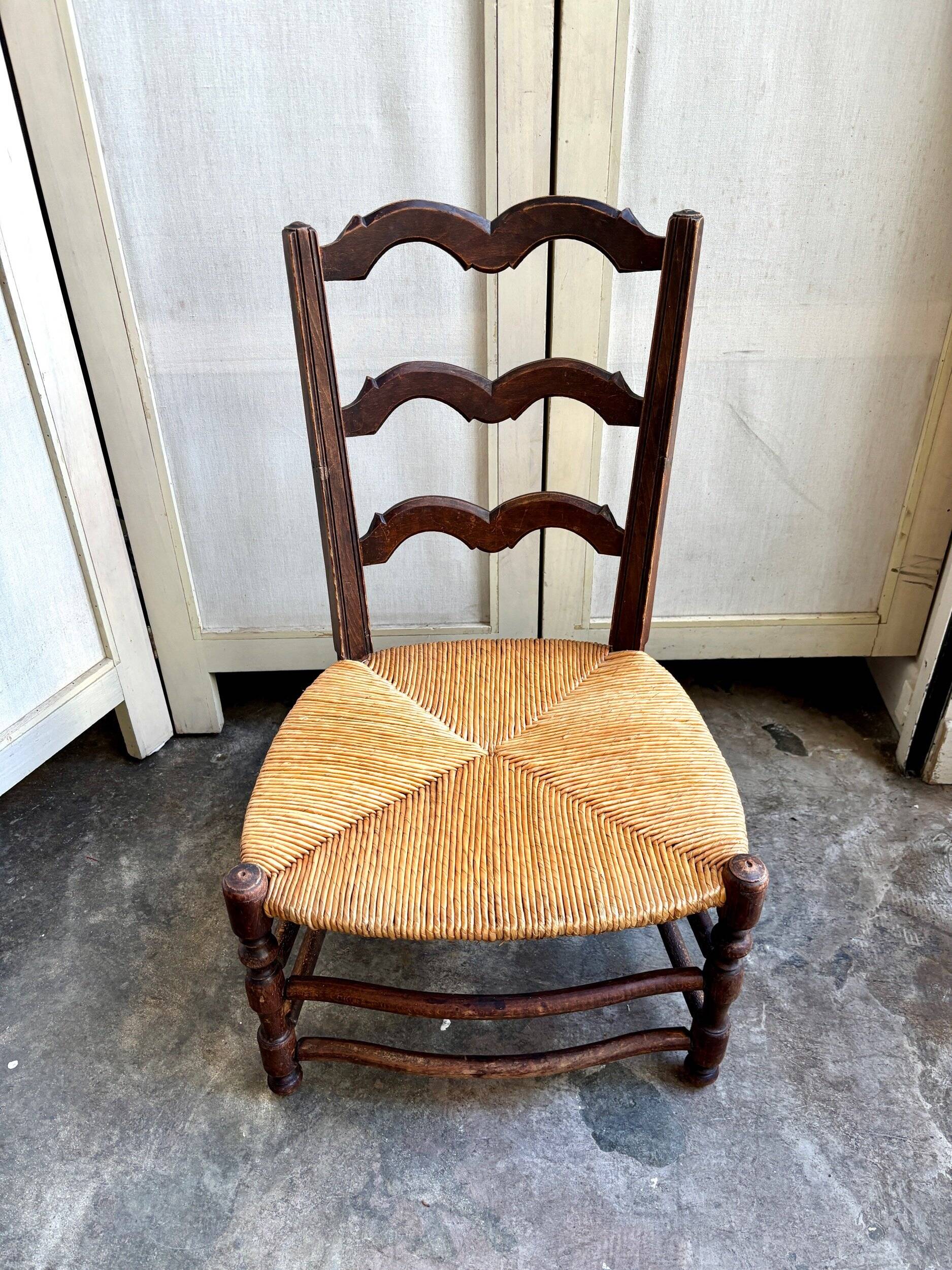 Low Provencal chair in dark wood and woven straw