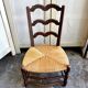 Low Provencal chair in dark wood and woven straw