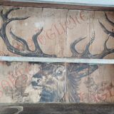 Craft cabinet with drawers with a very old tobacco advertisement in the background