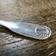 Small silver metal ladle from the Christofle brand, shell model