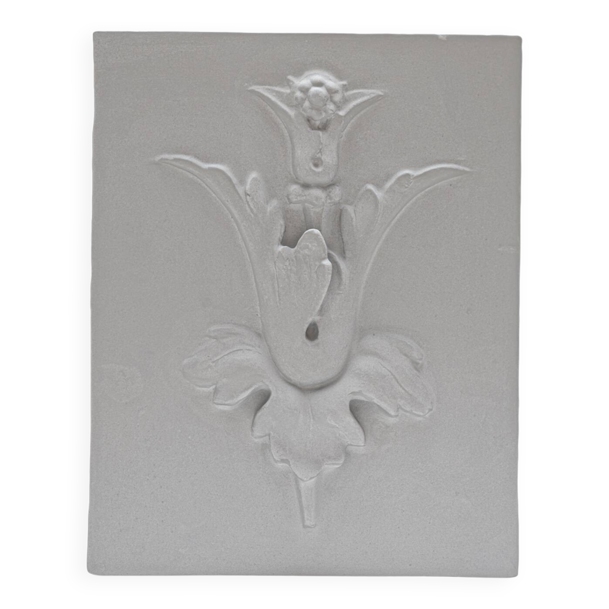 Bas-relief plaster mural with a fleur-de-lis design.