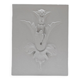 Bas-relief plaster mural with a fleur-de-lis design.