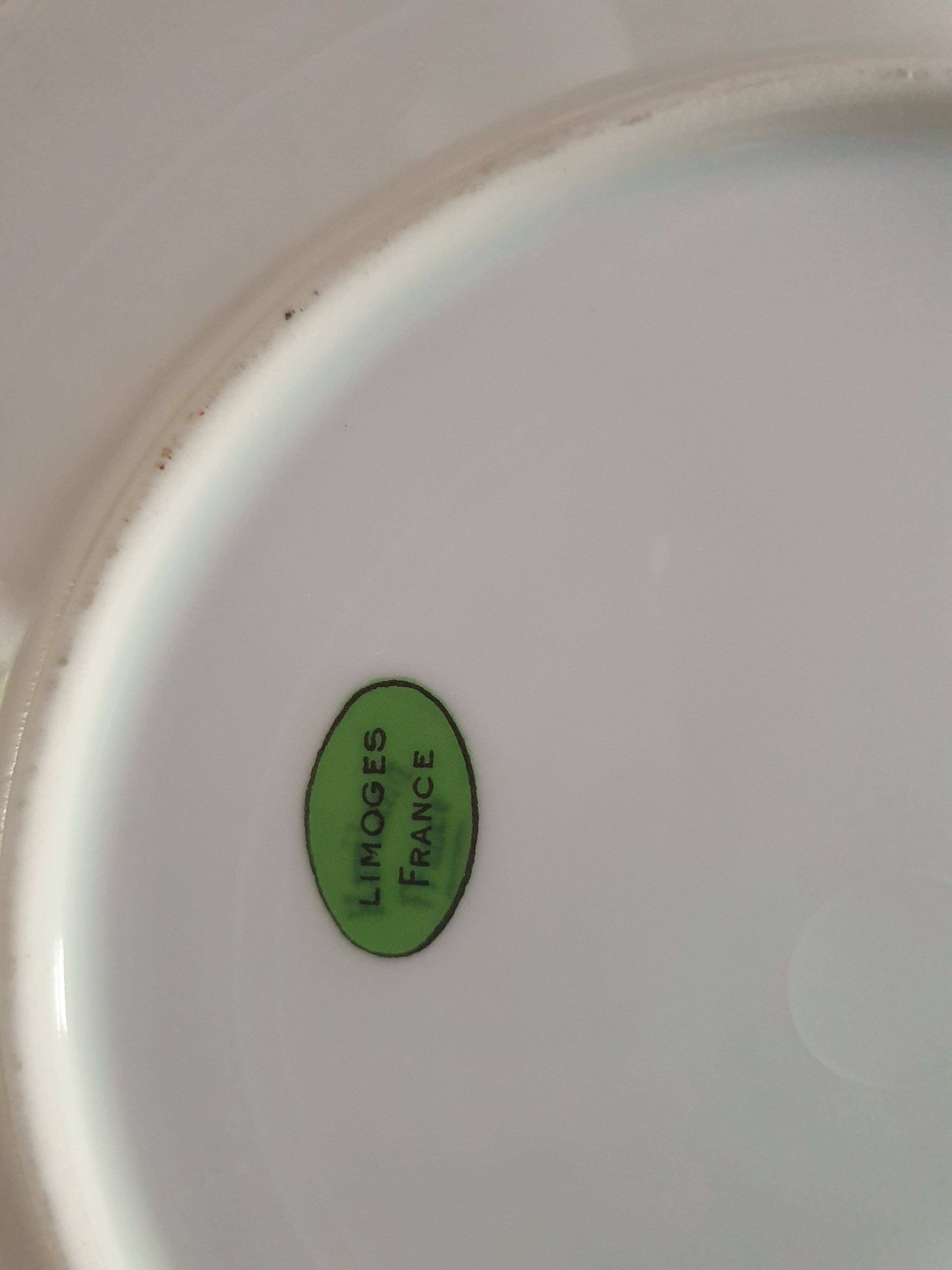 set of 4 dessert plates in white Limoges porcelain with flowers, the edge of one is different