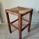 Antique campaign stool in solid wood with a straw seat.