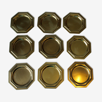 9 sous-verres en laiton, octogonaux, millésimés des années 1970