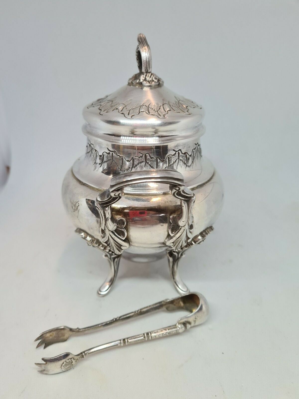 Silver metal sugar bowl with its clamp