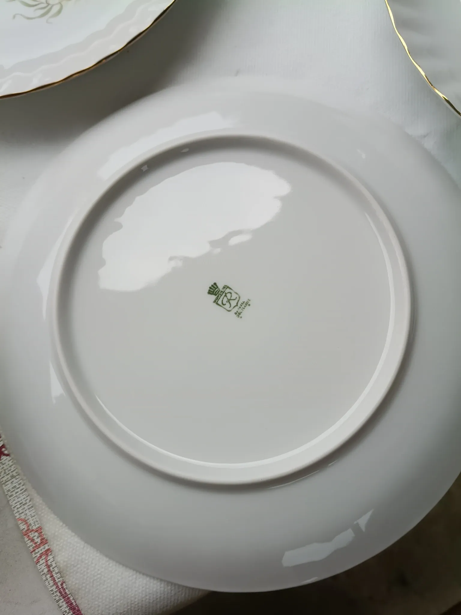 vintage porcelain dinner service with fish pattern and gold trim