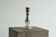Antique mercury glass candlestick with a patina and silver finish.