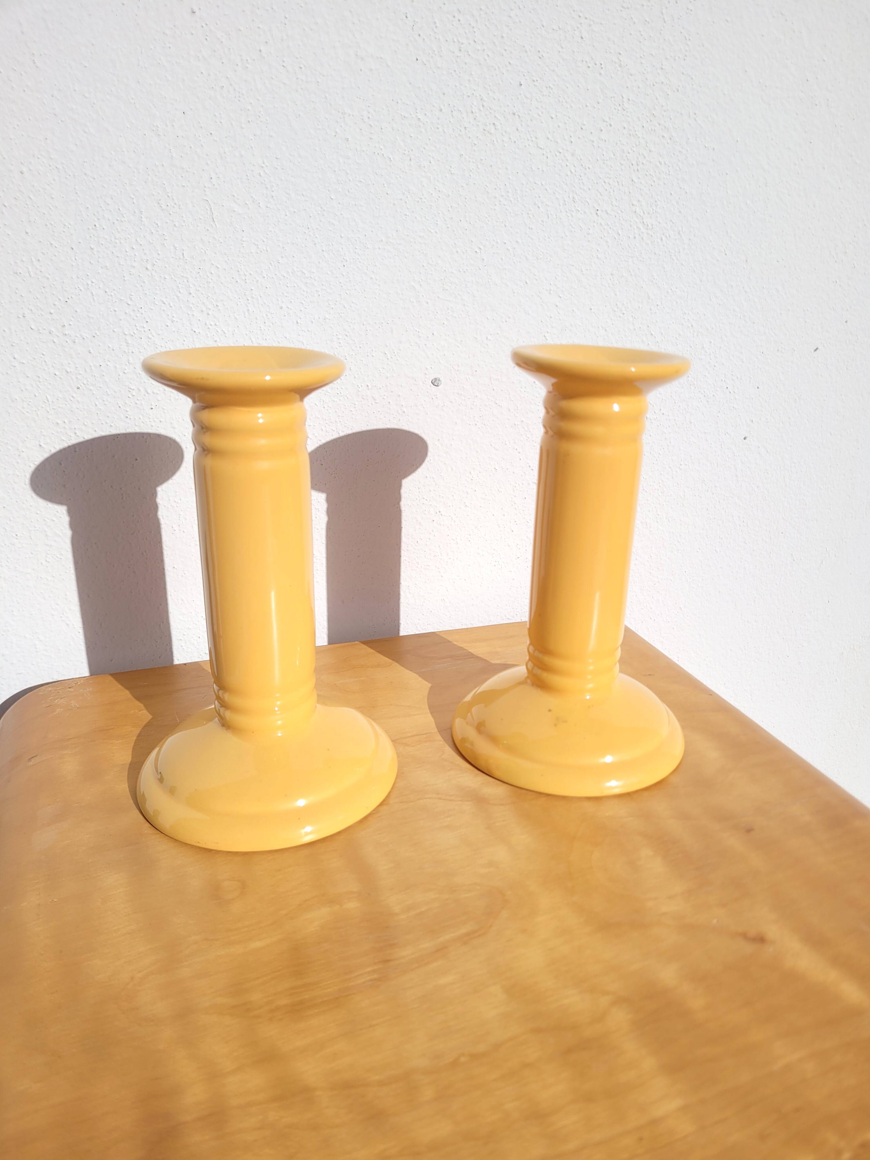 Pair of yellow ceramic candlesticks