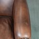 Great luxurious brown cowhide club armchair with matching piping
