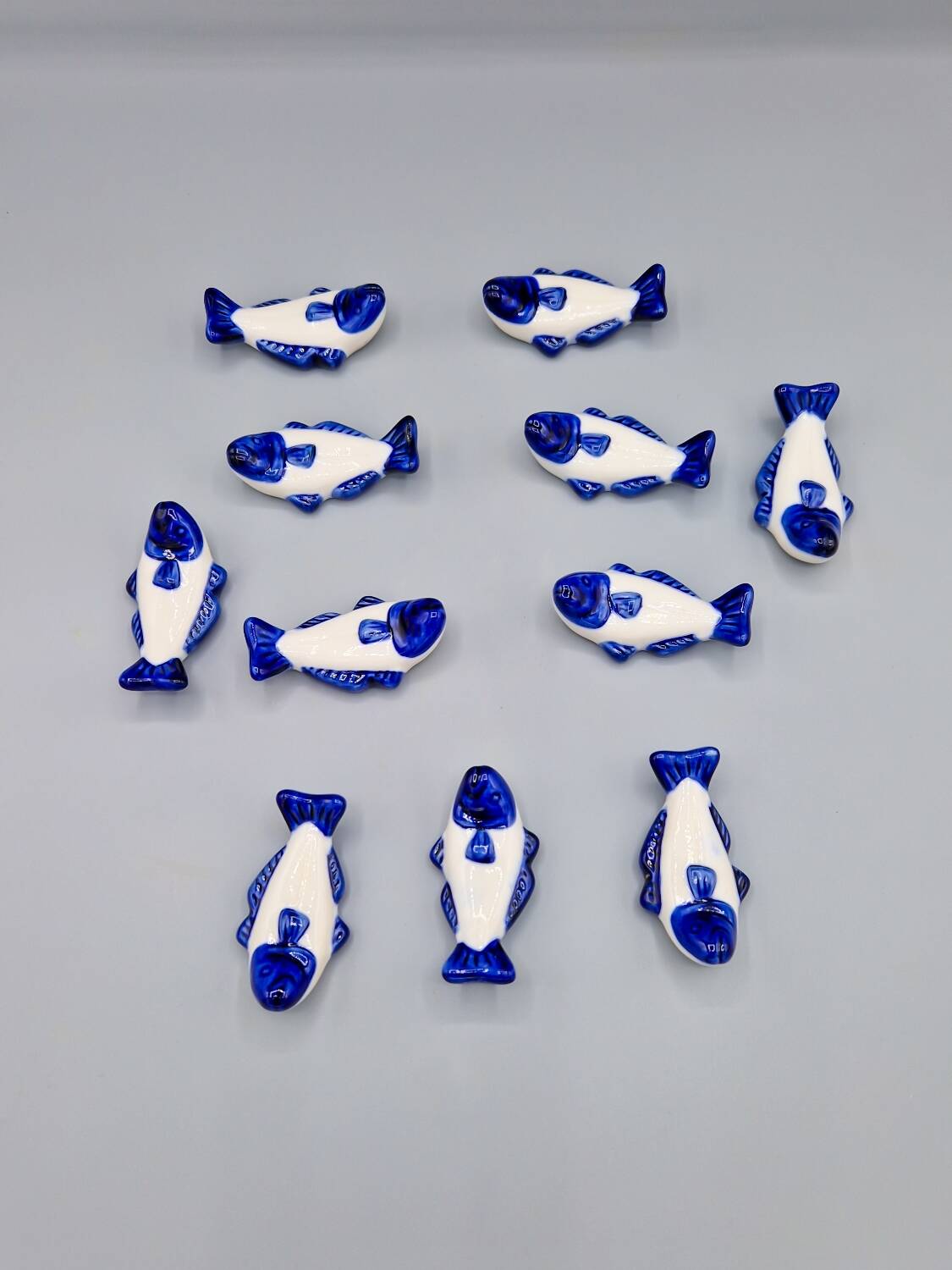 Set of 11 vintage blue and white porcelain fish knife rests.