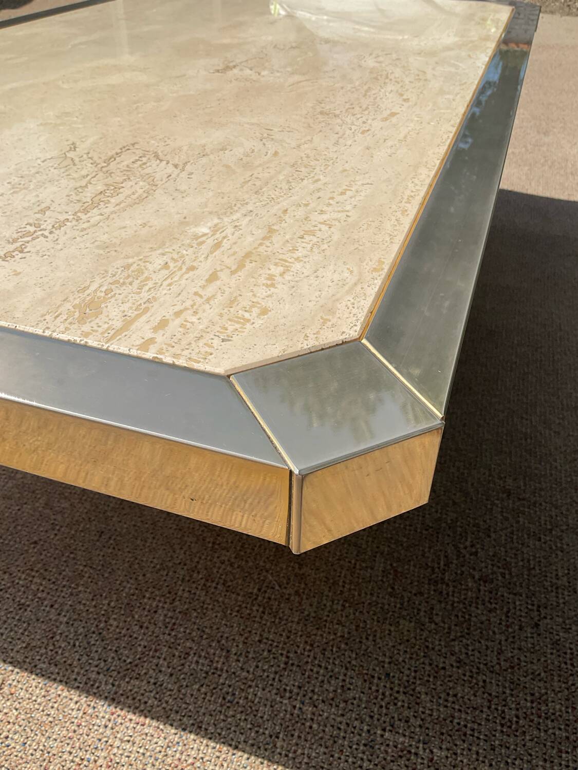 Vintage coffee table in travertine and brass.