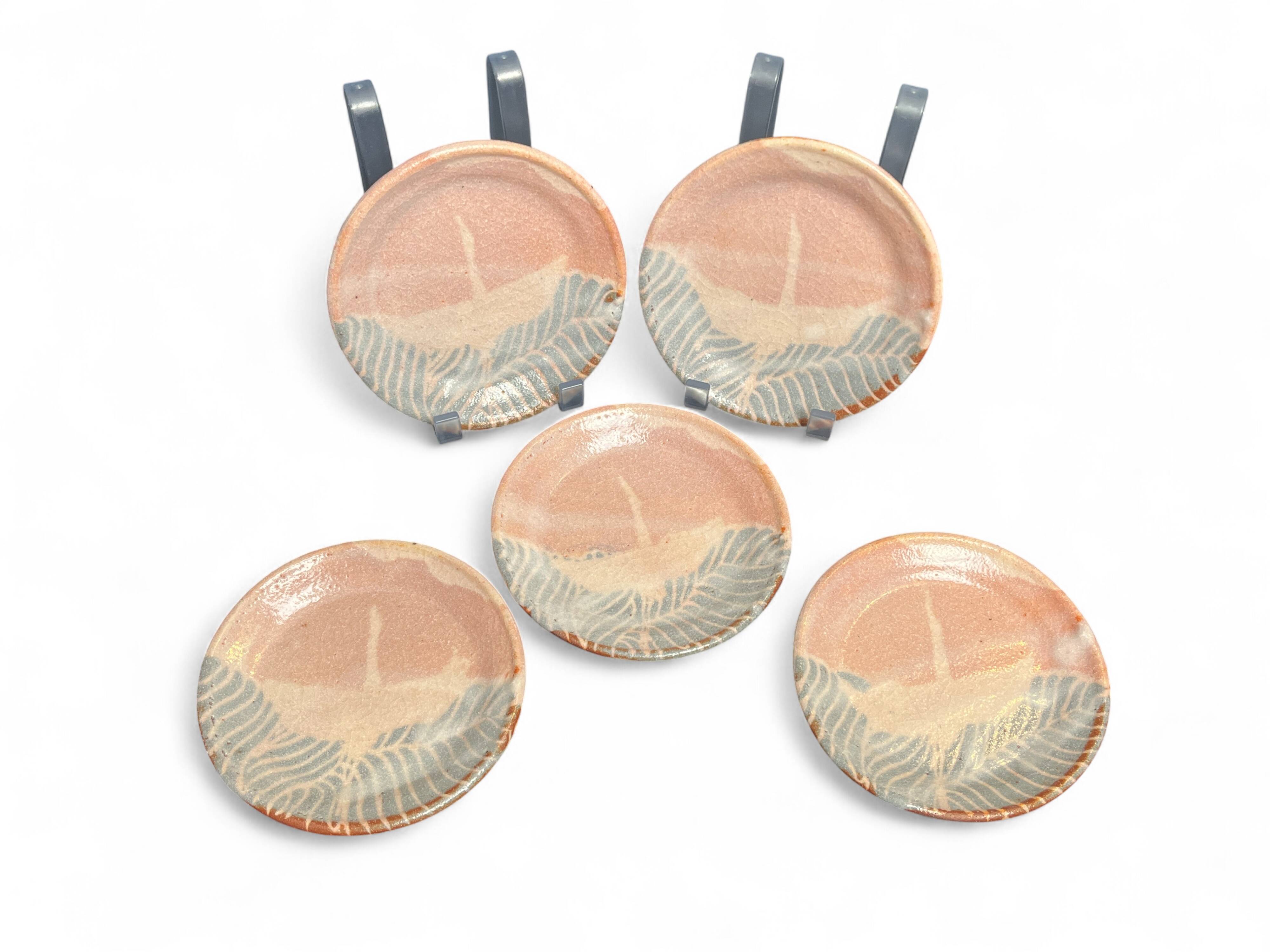 Set of five small Korean stoneware plates with pink crane, 20th century