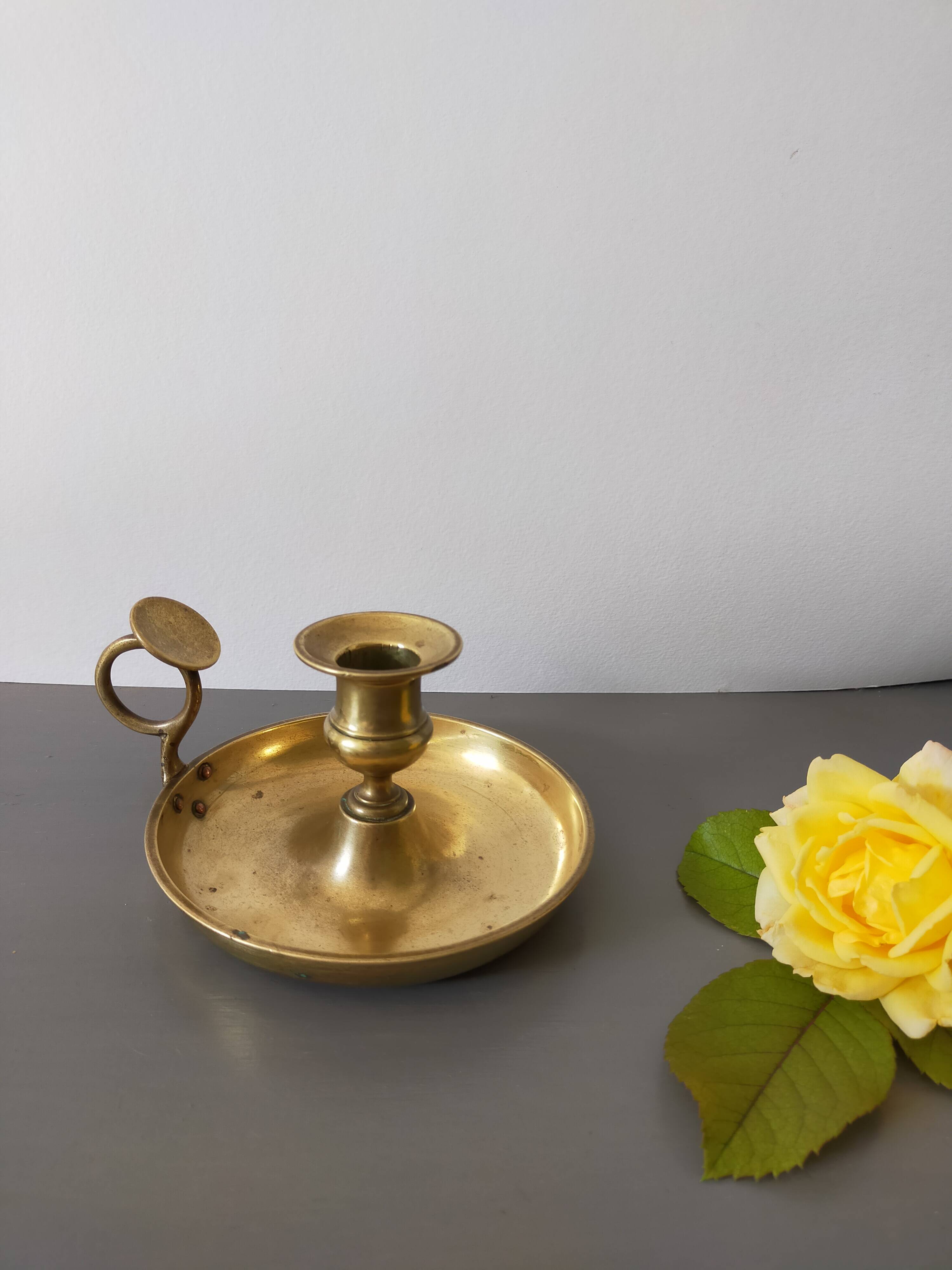 brass candle holder with old cellar rat thumb