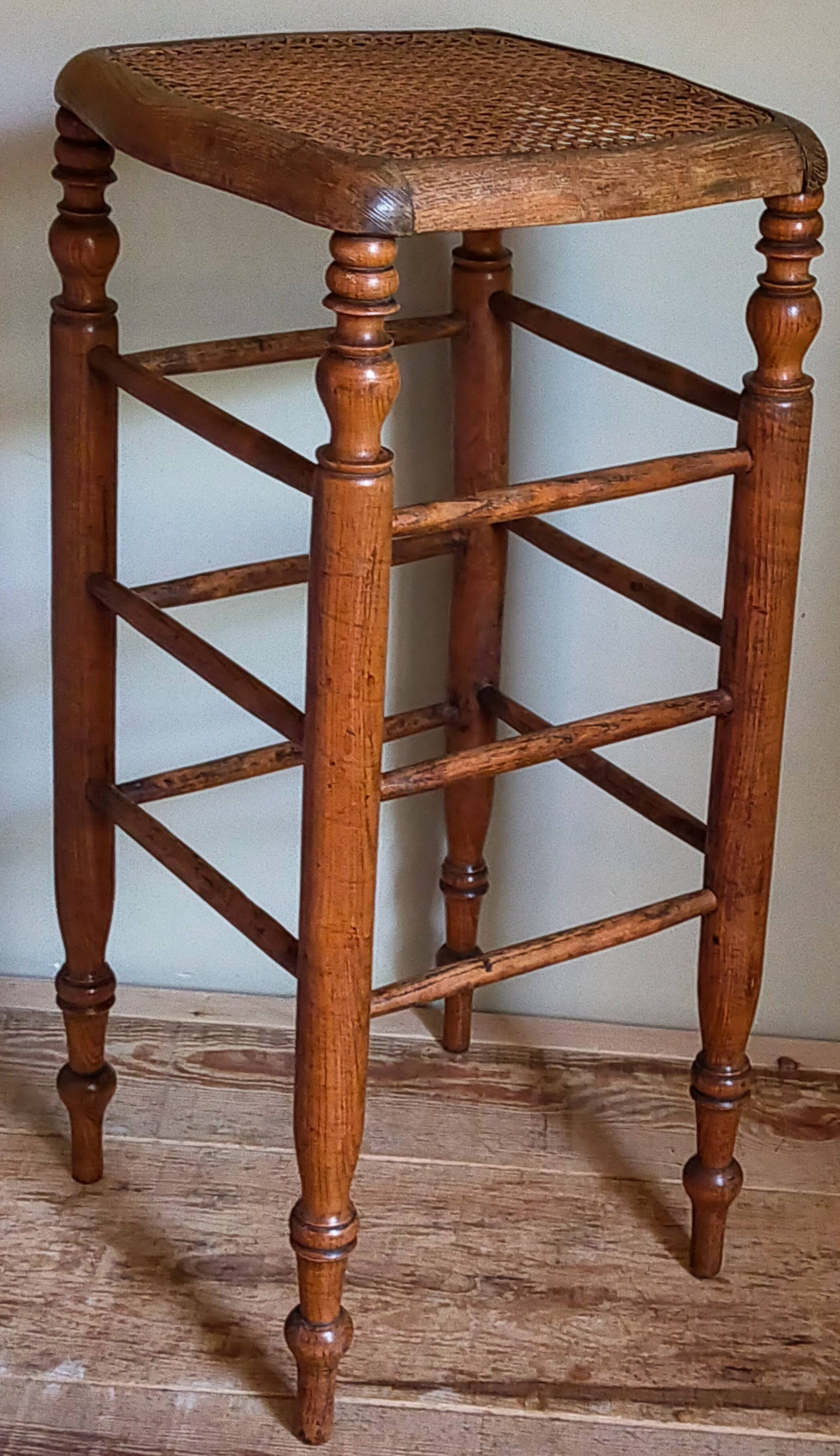 Antique stool with cane and turned wood