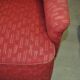 Pair of Mid-Century armchairs in red and brown fabric with dark wooden legs.