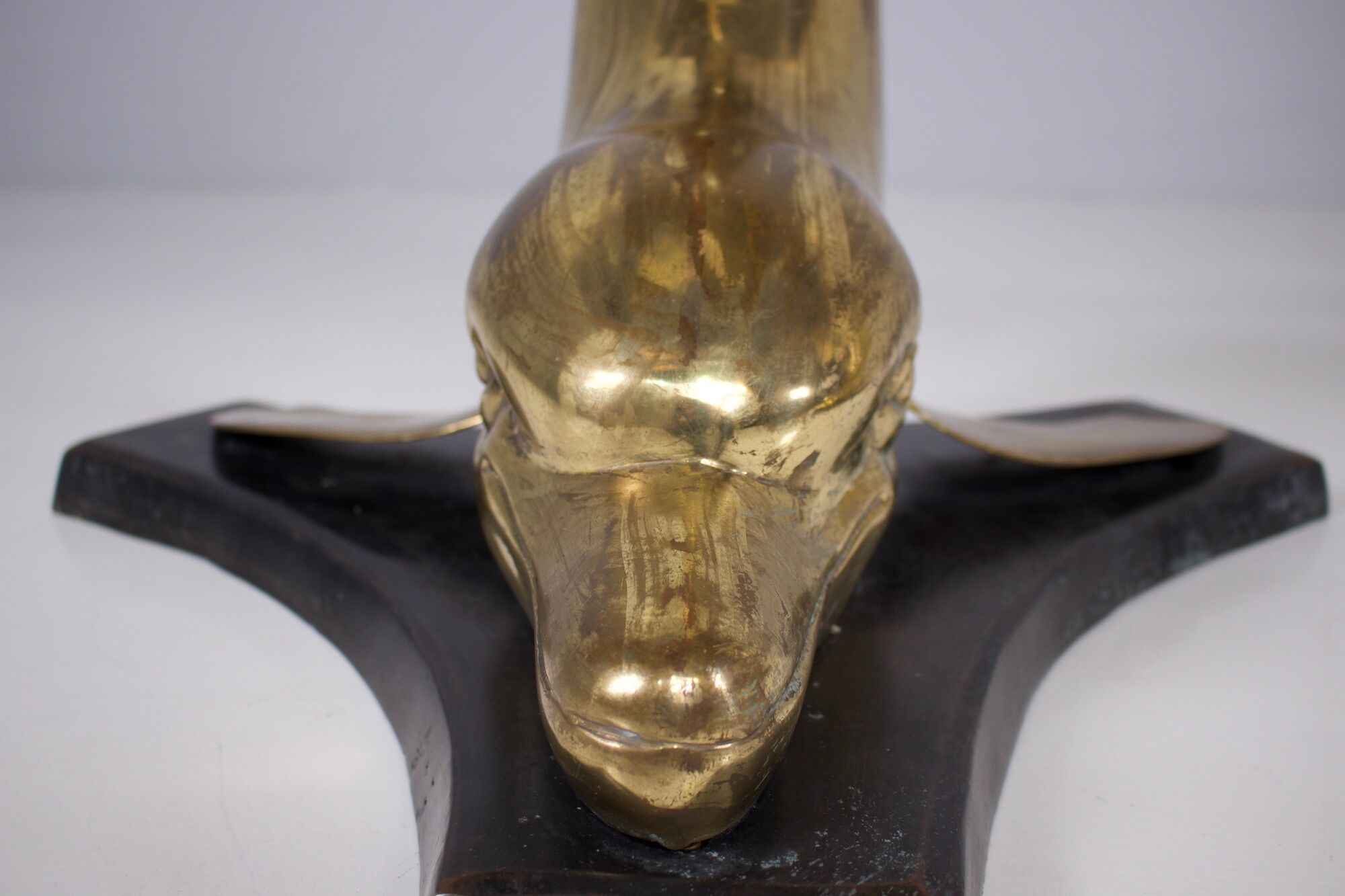 Solid brass dolphin console feet.
