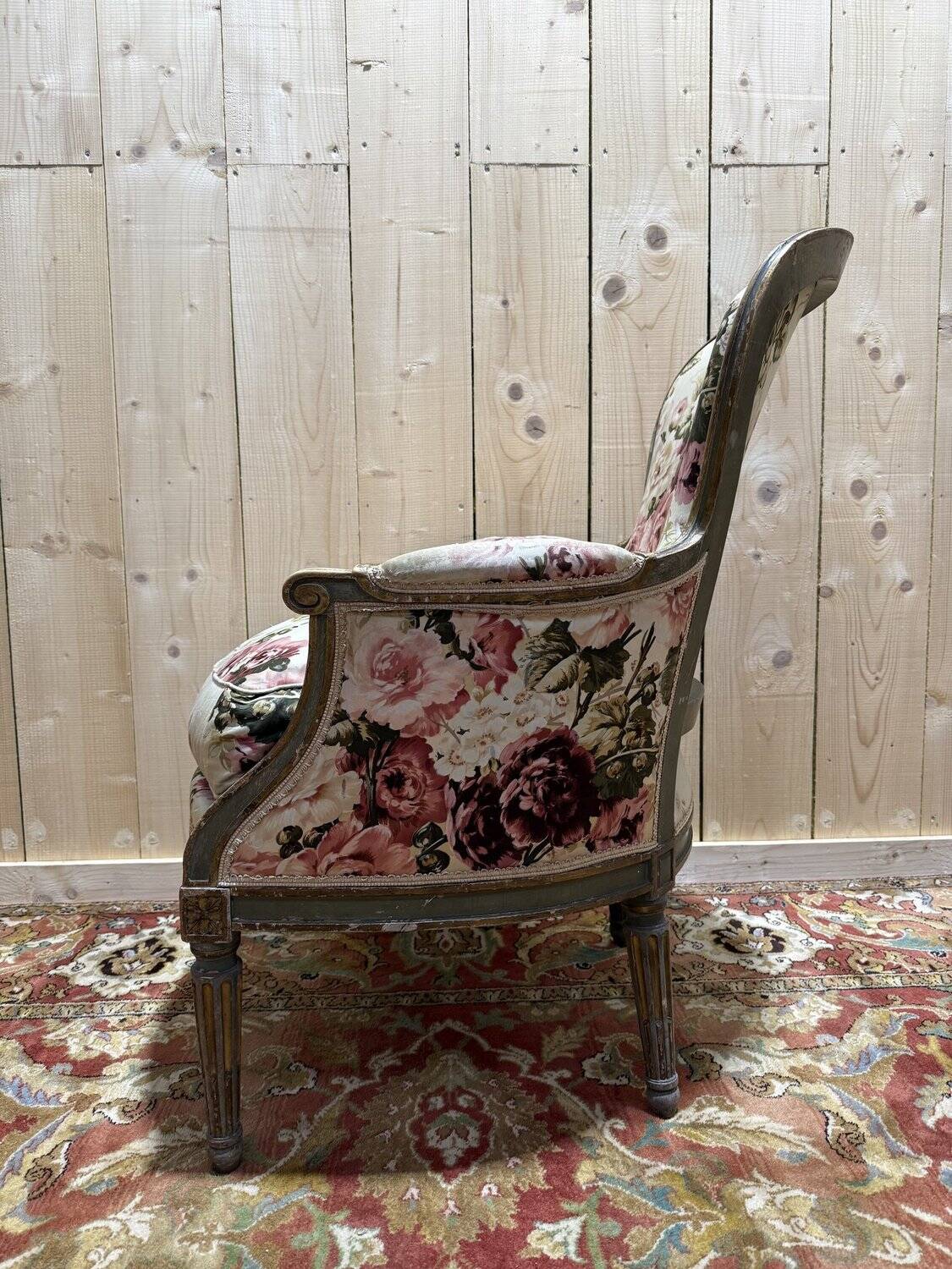 Reupholstered bergère with floral fabric in Louis XVI style.