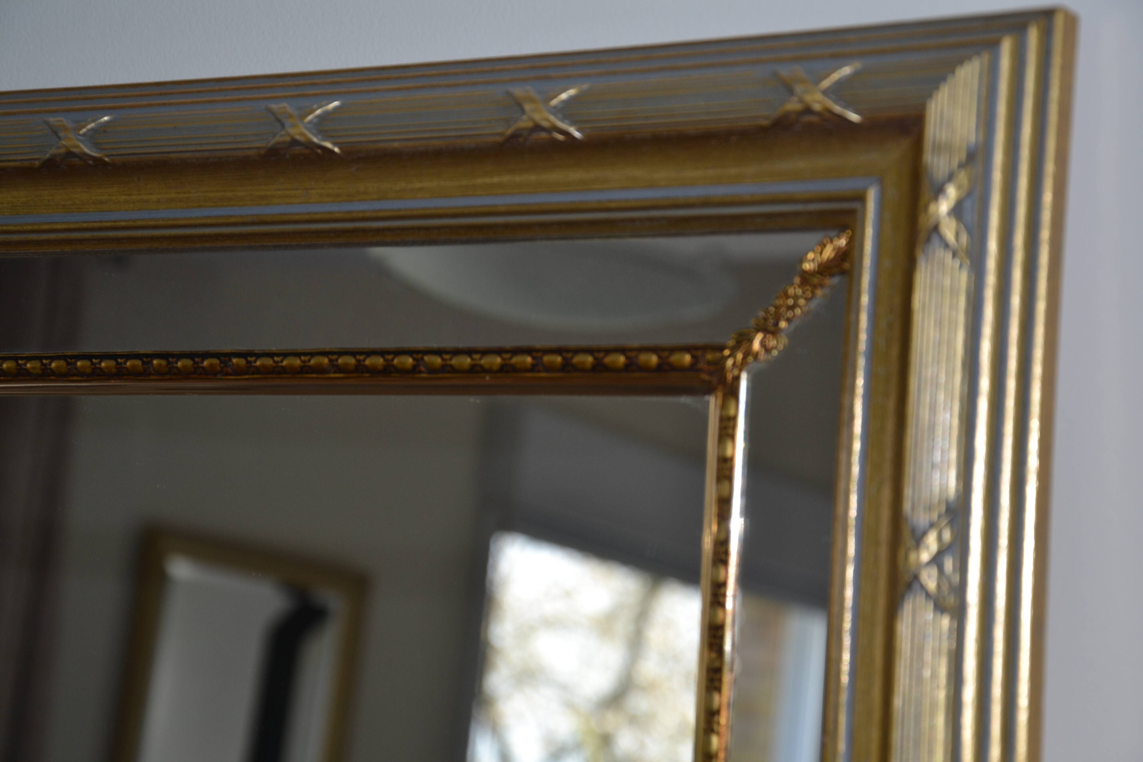 Large mirror with wooden gilded and carved frame.