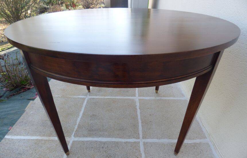 Round mahogany table with mahogany veneer and brass sabot foot.