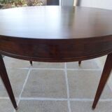 Round mahogany table with mahogany veneer and brass sabot foot.