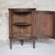 Antique wooden corner cabinet with a curved door.