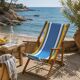 Vintage deck chair with blue and yellow striped fabric, original patina.