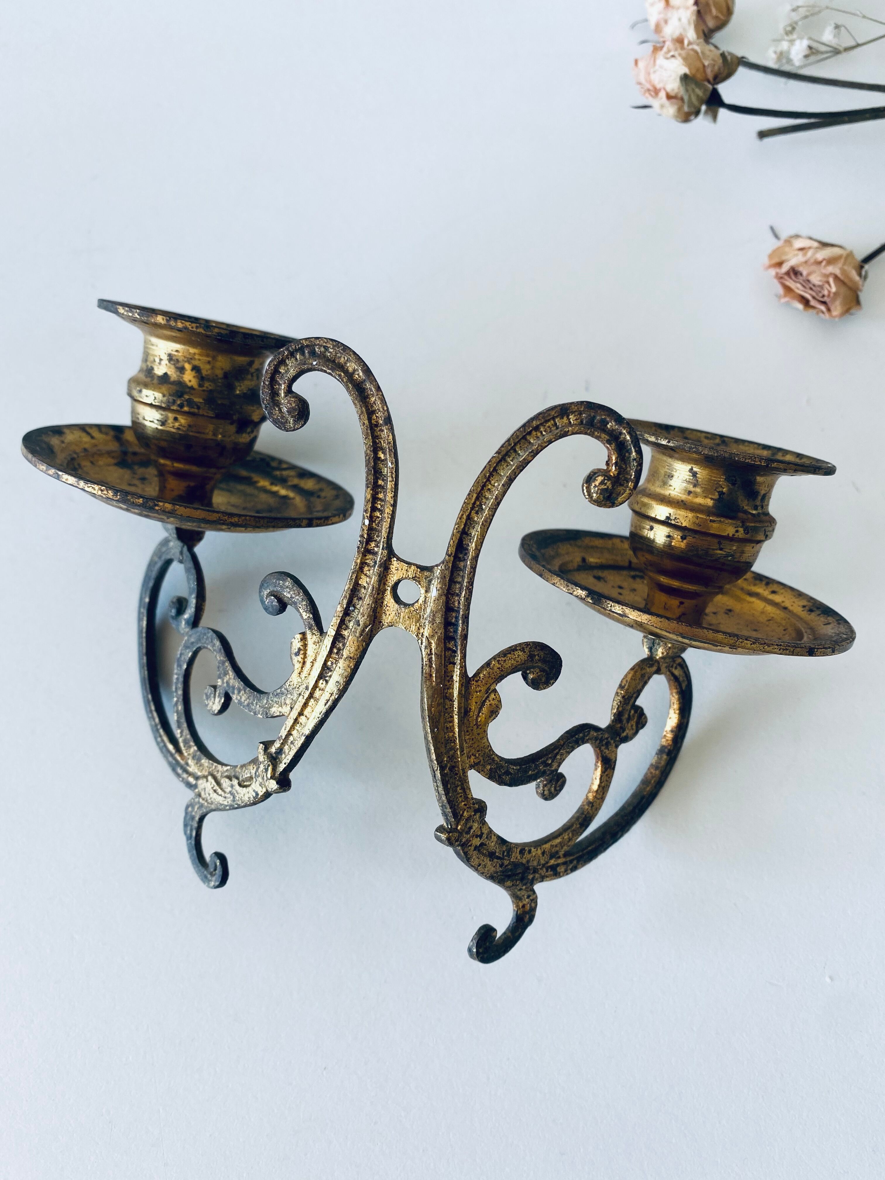 Old wall candle holder in golden brass