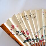 Vintage bamboo fan with floral decoration from China.