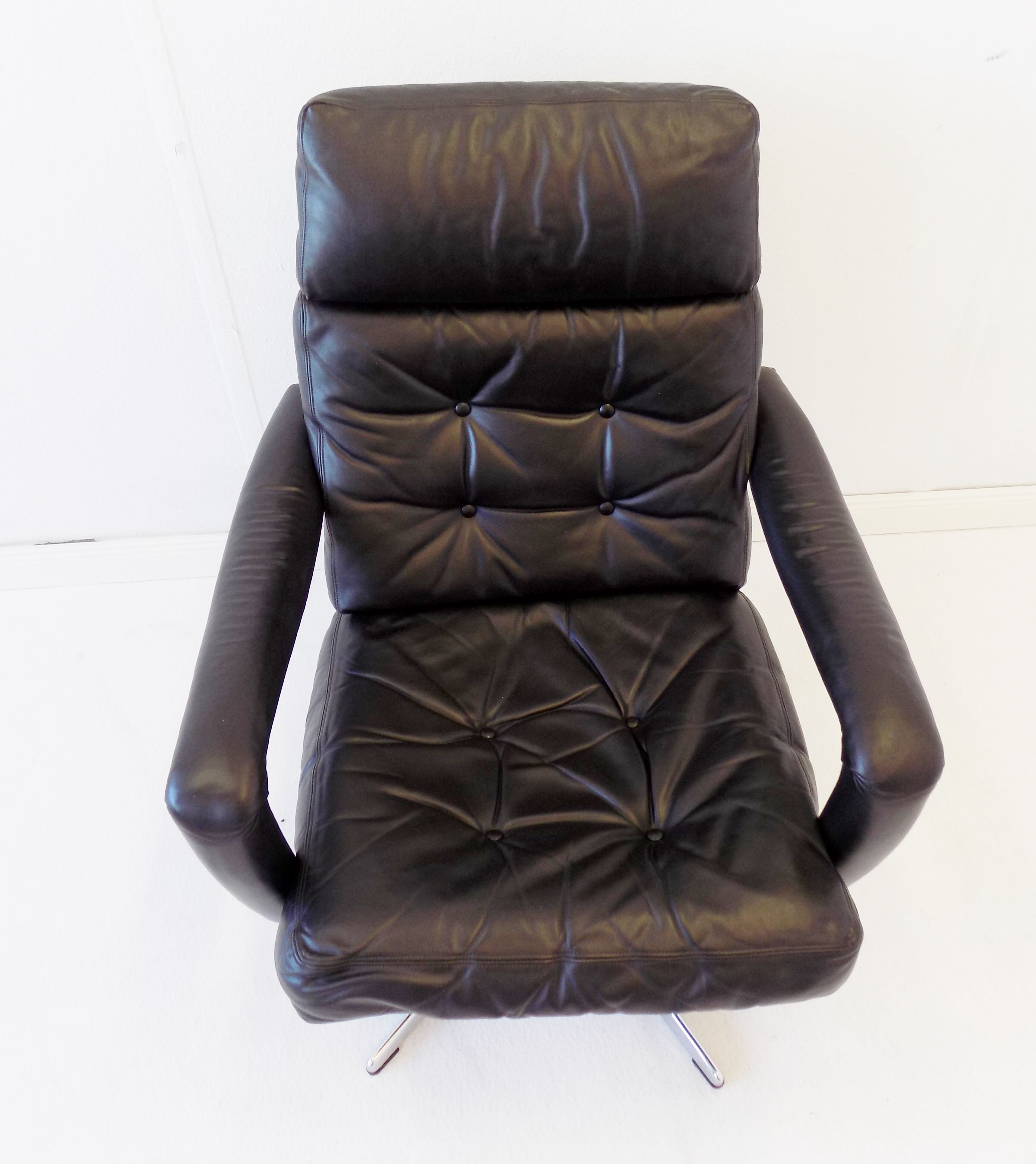 Danish black leather armchair with ottoman 70s