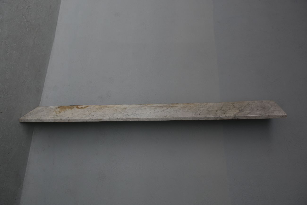 Old fireplace in white marble veined Louis XVI